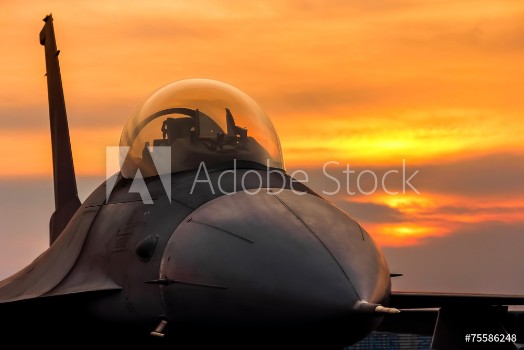 Picture of F16 falcon fighter jet on sunset background